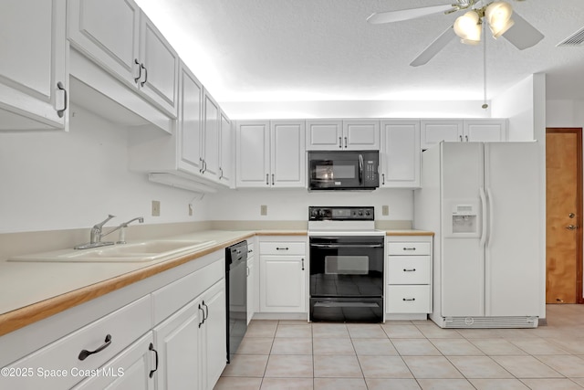 kitchen with ceiling fan, black appliances, sink, light tile patterned floors, and white cabinets