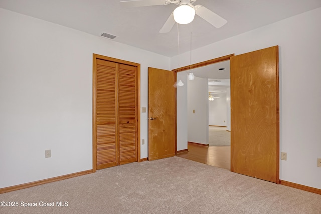 unfurnished bedroom with ceiling fan, a closet, and light colored carpet