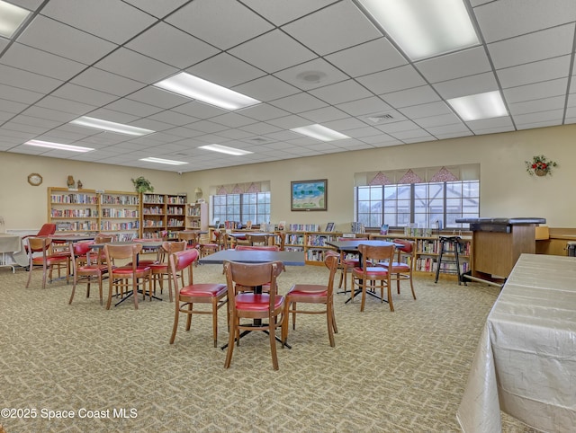 dining room with a drop ceiling