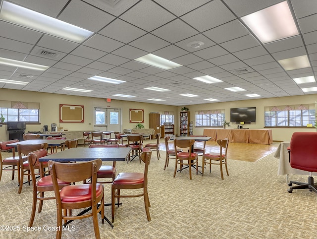 dining area featuring a drop ceiling