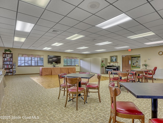 dining room with a drop ceiling