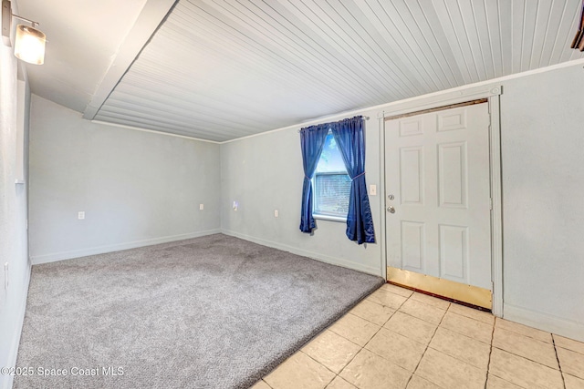 spare room with ornamental molding and light tile patterned floors