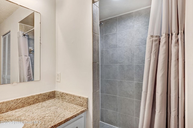 bathroom with a textured ceiling and vanity