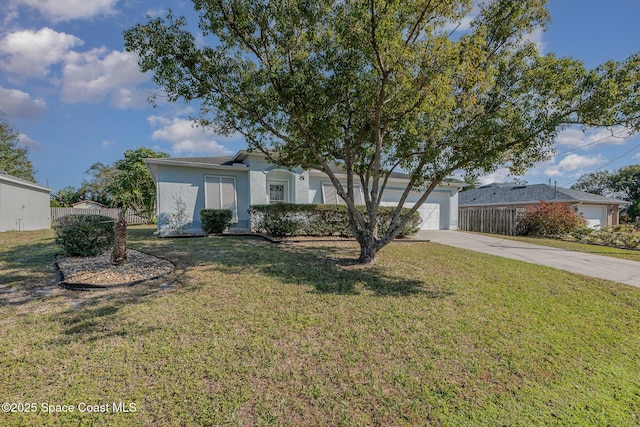 single story home with a garage and a front lawn