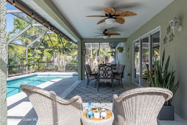 sunroom featuring ceiling fan and a pool