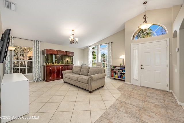 tiled foyer with a notable chandelier and vaulted ceiling