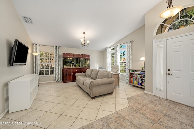 living room featuring an inviting chandelier, lofted ceiling, and light tile patterned flooring