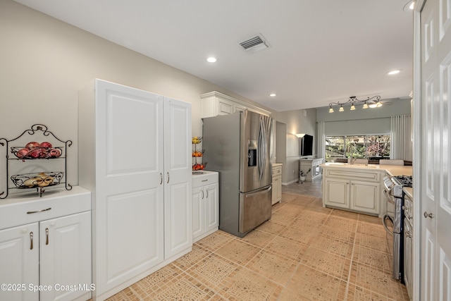 kitchen with white cabinetry and stainless steel appliances