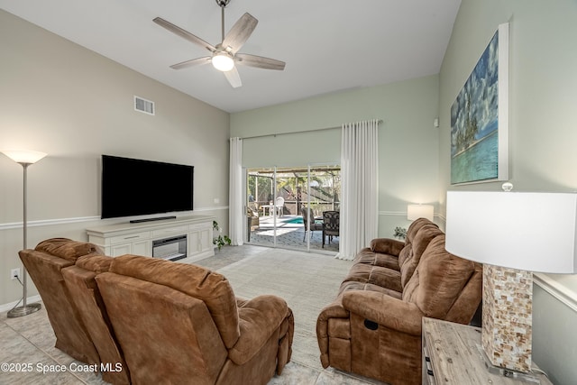 tiled living room with ceiling fan and vaulted ceiling