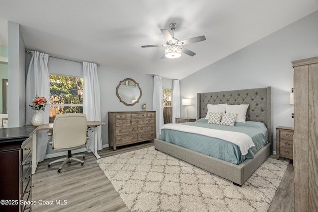 bedroom featuring ceiling fan, light hardwood / wood-style floors, and vaulted ceiling