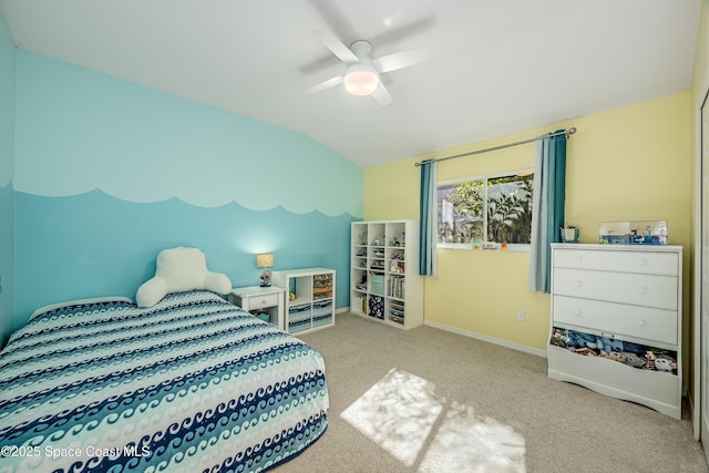 carpeted bedroom featuring vaulted ceiling and ceiling fan