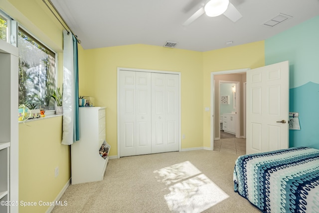 carpeted bedroom featuring ceiling fan and a closet