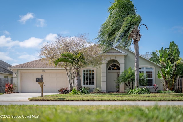 view of front of home featuring a front yard and a garage