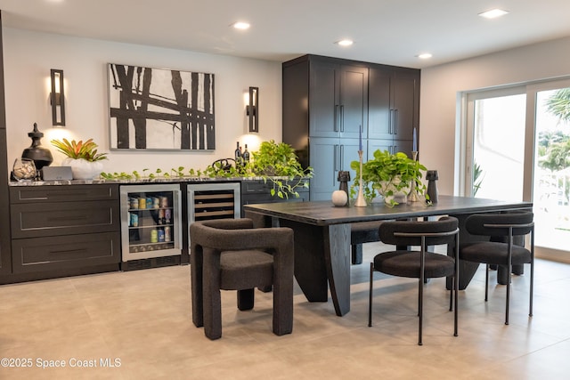 bar with beverage cooler and dark brown cabinetry