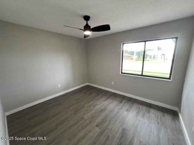 unfurnished room featuring a textured ceiling, ceiling fan, and dark hardwood / wood-style floors