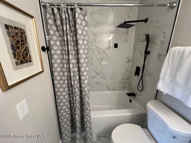 bathroom featuring shower / bath combination with curtain and toilet