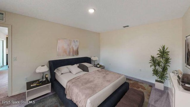 carpeted bedroom featuring a textured ceiling