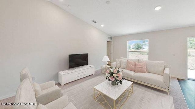 living room featuring light wood-type flooring and lofted ceiling