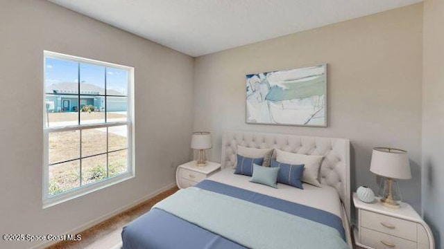 carpeted bedroom featuring multiple windows