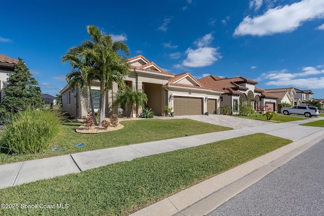 mediterranean / spanish house with a front yard and a garage