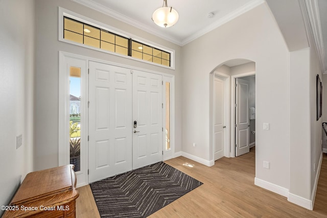 entrance foyer with hardwood / wood-style floors and ornamental molding