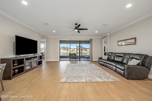 living room featuring crown molding and light wood-type flooring