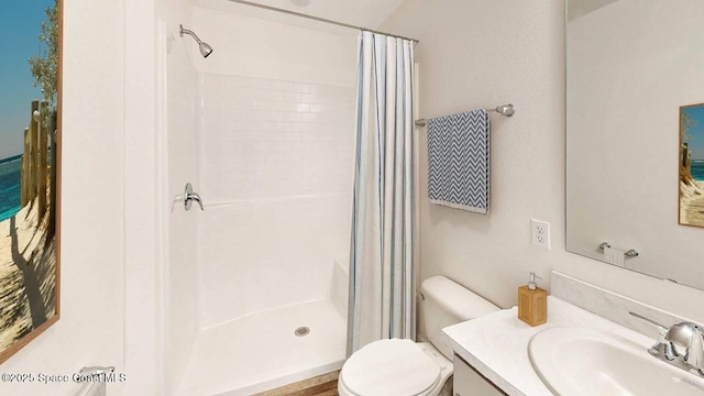 bathroom featuring toilet, vanity, and a shower with shower curtain