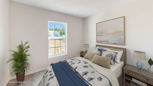 carpeted bedroom with a textured ceiling