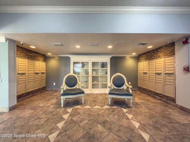 living area featuring a mail area, ornamental molding, and a package area