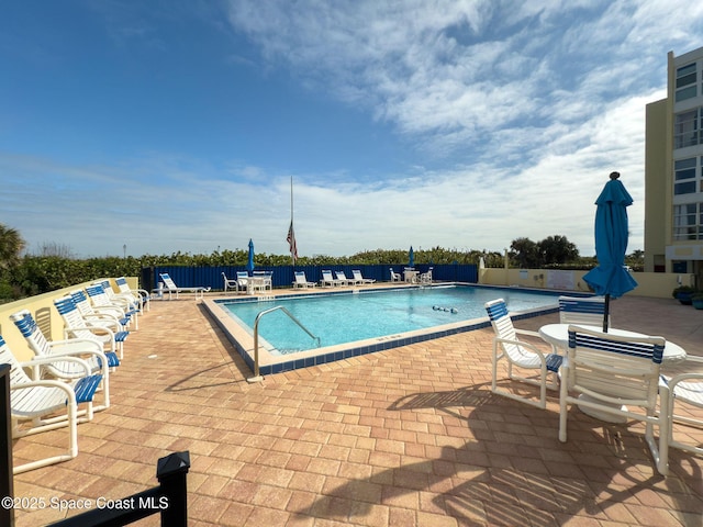 view of swimming pool with a patio