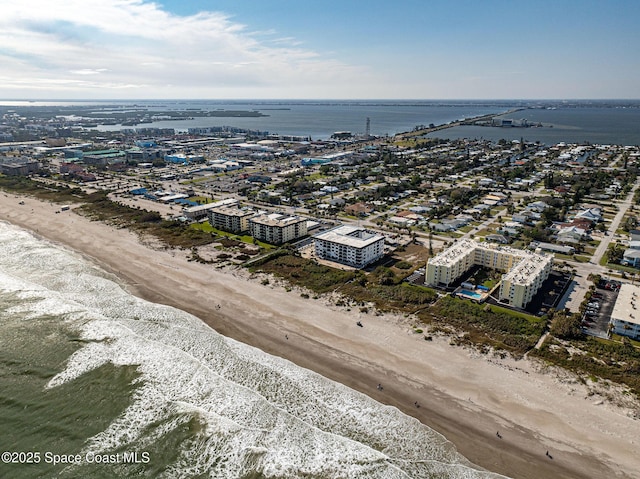 drone / aerial view with a beach view and a water view