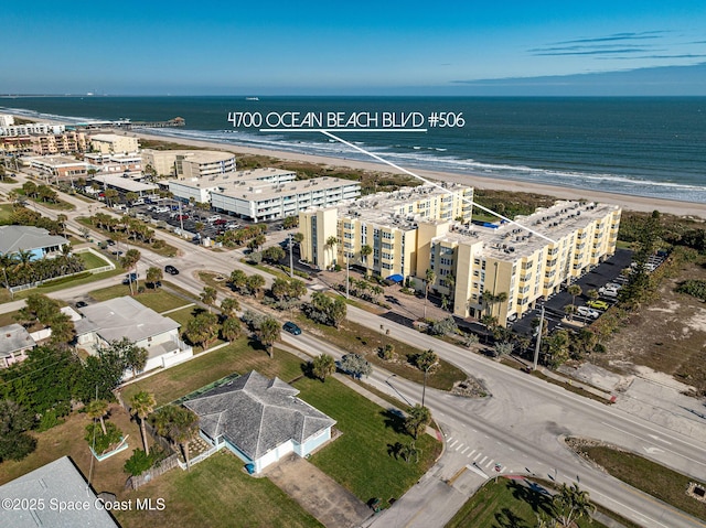 bird's eye view featuring a water view and a view of the beach