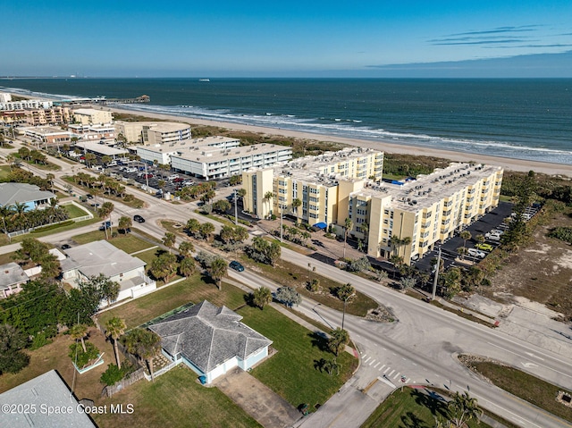 drone / aerial view featuring a water view and a beach view