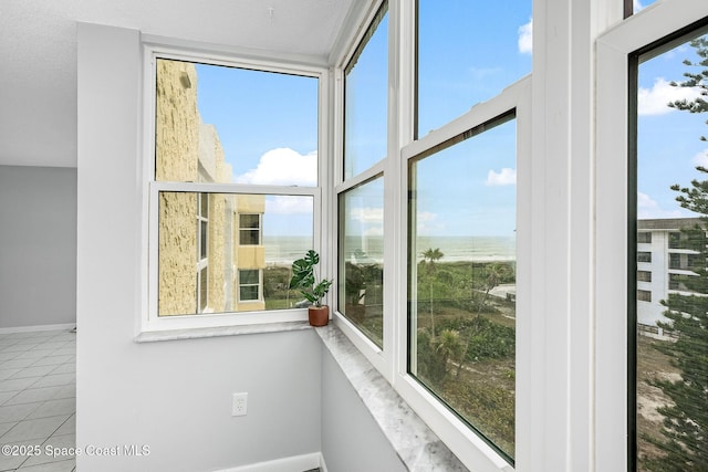 interior space with a water view and a wealth of natural light