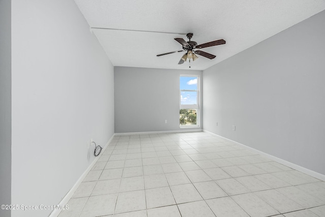 tiled spare room featuring a textured ceiling and ceiling fan