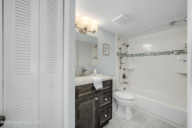 full bathroom with toilet, vanity, and tiled shower / bath combo