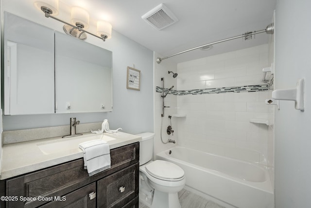 full bathroom with toilet, tiled shower / bath combo, and vanity