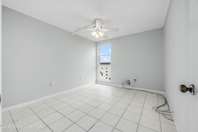 tiled empty room featuring ceiling fan