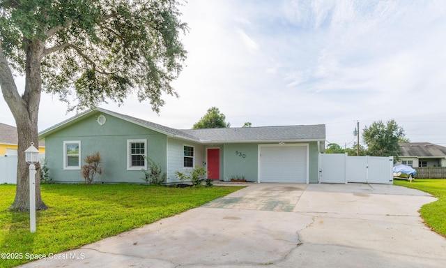 single story home featuring a front lawn and a garage