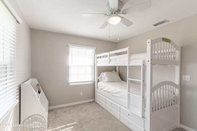 bedroom featuring ceiling fan and light carpet