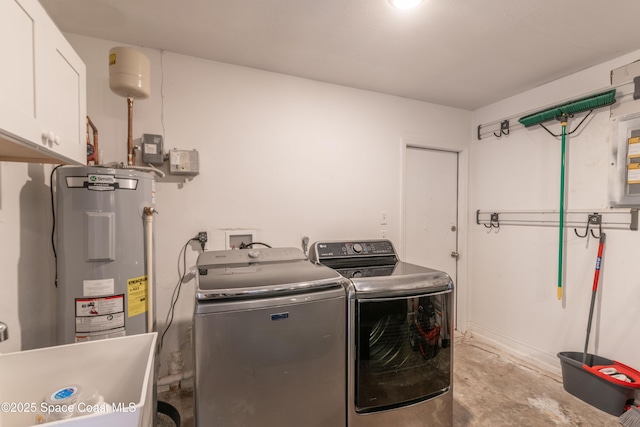 laundry room featuring cabinets, electric water heater, separate washer and dryer, and sink