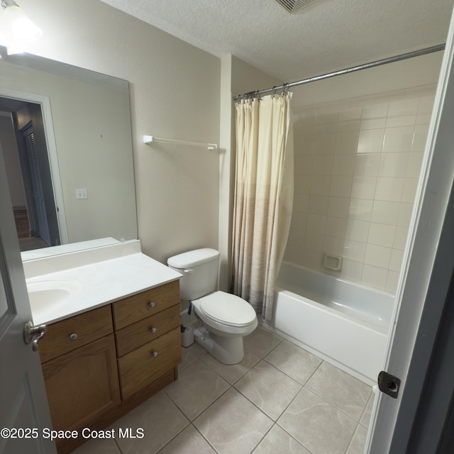 full bathroom featuring tile patterned flooring, a textured ceiling, toilet, shower / bath combo with shower curtain, and vanity