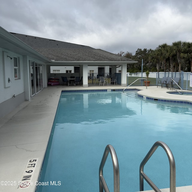 view of swimming pool with a patio