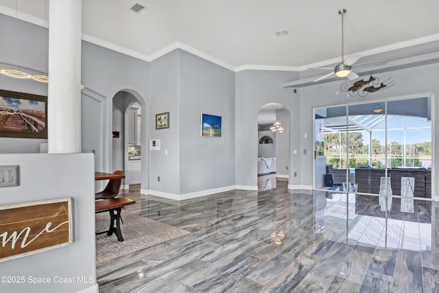 interior space featuring ceiling fan and crown molding