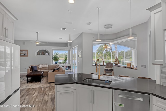 kitchen with white cabinets, ceiling fan, dishwasher, and sink