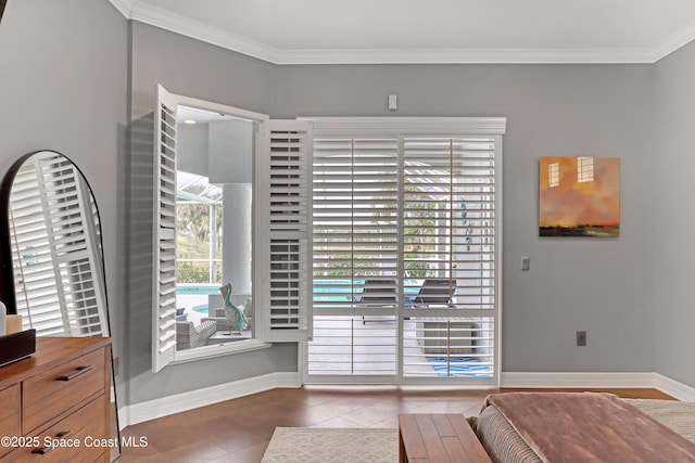 interior space with dark tile patterned floors and ornamental molding