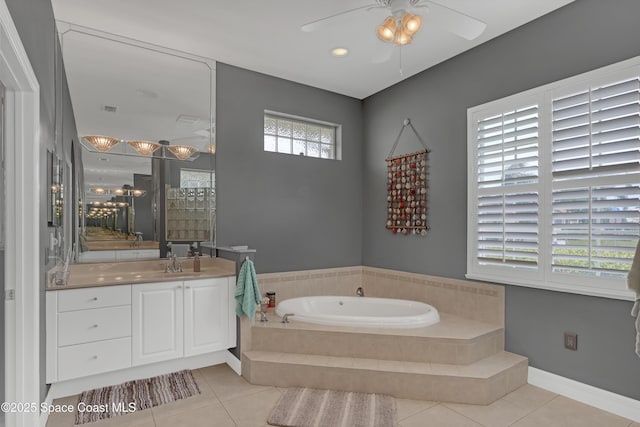 bathroom featuring tile patterned flooring, vanity, and tiled tub