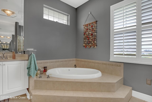 bathroom with tiled tub and vanity