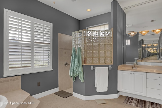 bathroom with tile patterned floors, vanity, and separate shower and tub