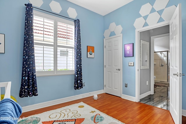 bedroom with hardwood / wood-style flooring